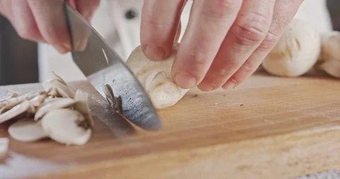 Close up of a chef knife slicing champignon mushrooms Stock-Footage 125535473