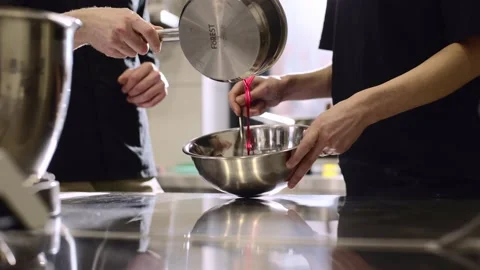 Close up. A chef makes ganache to decorate desserts. Stock Footage 233299621