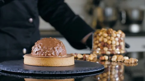 Close-up of chef is making dessert with milk chocolate and nuts Stock Footage 125112141