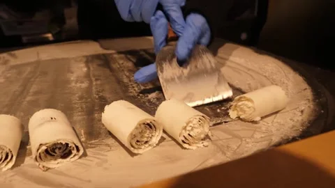 Close-up of Chef Making Rolled Ice Cream on Cold Plate Stock-Footage 345293178