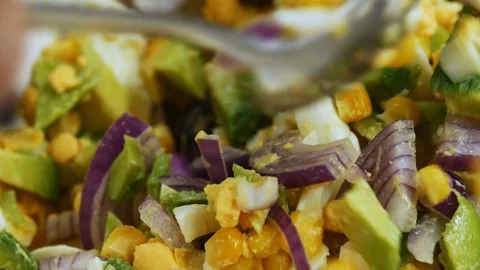 Close-up of chef mixes ingredients of vegetable salad in a bowl. Preparation of Stock Footage 103625539