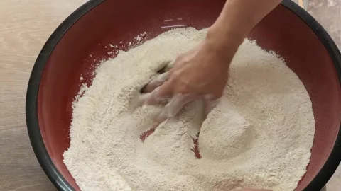 Close-up of Chef Mixing Dry Flour Ingredients in a Large Red Bowl Stock Footage 333522187