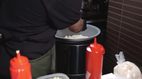 Close-up of a chef mixing sushi rice in a large bowl in a restaurant kitchen. Stock Footage 323911547