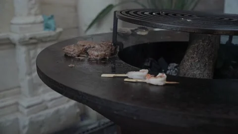 Close-up chef picks up toasted meat cutlets with a metal shovel from a hot grill Stock Footage 195121443