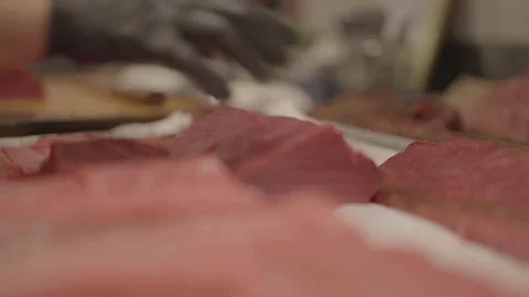 Close-up of chef placing meat on baking tray Stock Footage 336374492