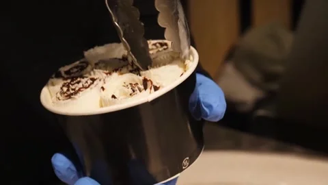 Close-up of Chef Placing Rolled Ice Cream with Chocolate Drizzle into a Cup Stock-Footage 345293180