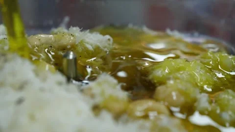 Close-up of Chef Pouring Extra Virgin Olive Oil onto Raw Italian Pizza Dough and Stock Footage 337678138