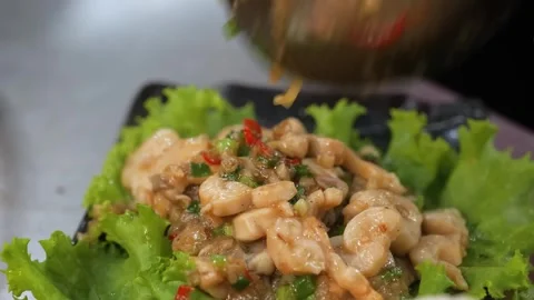 Close-Up of Chef Pouring Gourmet Stir-Fried Geoduck Clam onto Lettuce Platter Видео 344230504