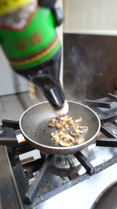 Close-up of chef pouring sauce on mushroom while preparing vegan burger Stock Footage 340407490