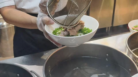 Close up of Chef Prep Pho shows fresh meat in strainer. Expert Chef Prep Pho is Stock Footage 325490799