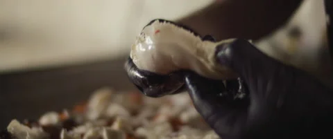 Close up of a chef preparing burrata cheese to place over a pizza al taglio. Stock Footage 146605478