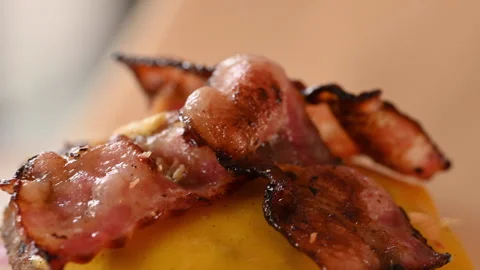 Close up of a chef preparing a double hamburger. Bacon with ham and cheese. Stock Footage 296071891