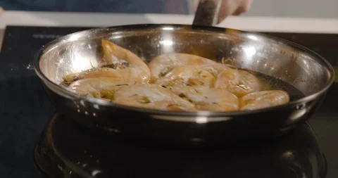 Close up of a chef preparing flambe dish shrimp on a frying pan. Stock Footage 124006518