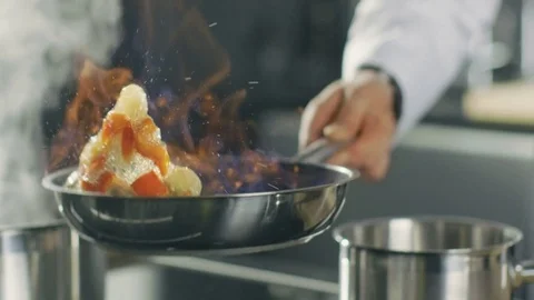 Close-up of a Chef Preparing Flambe Style Dish on a Pan. Oil and Alcohol Ignite  Stock Footage