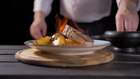 Close-up of a Chef Preparing Flambe Style Dish on a Pan. Oil and Alcohol Ignite Stock Footage 127055625