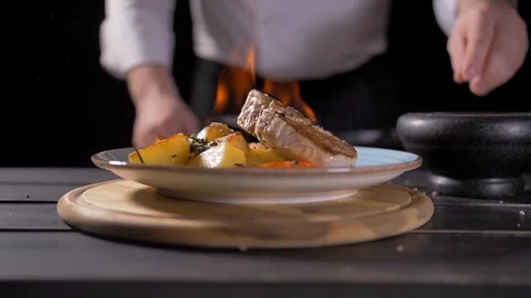 Close-up of a Chef Preparing Flambe Style Dish on a Pan. Oil and Alcohol Ignite Stock Footage 127056794