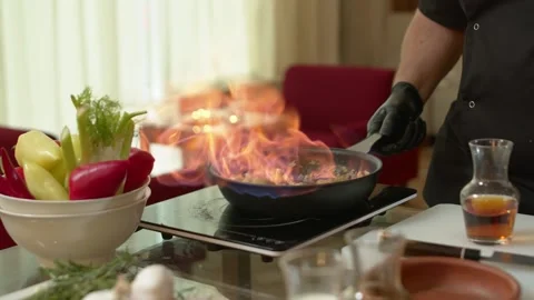 Close-up of a Chef Preparing Flambe Style Dish on a Pan. Open Flames Stock Footage 137318862