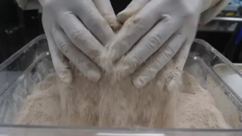 Close-up of a Chef Preparing a Fresh, Peeled Pineapple by Rolling it in Sugar an Vídeos de archivo 332811546