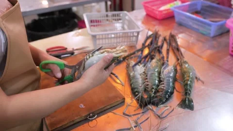 Close-Up of Chef Preparing Giant River Prawns with Scissors on Cutting Board Video stock 344216846