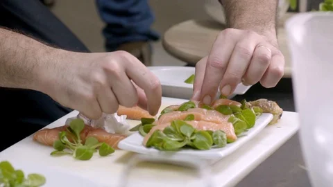 Close up of chef preparing salmon with lettuce, meal, Portugal Stock Footage 129068745
