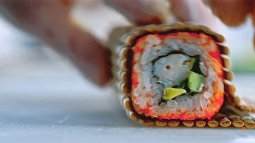 Close up of a chef preparing sushi roll in a restaurant Stock Footage 85590311