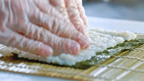 Close up of a chef preparing sushi roll in a restaurant Stock Footage 85590946