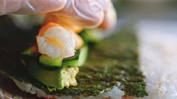 Close up of a chef preparing sushi roll in a restaurant Stock Footage 85590973