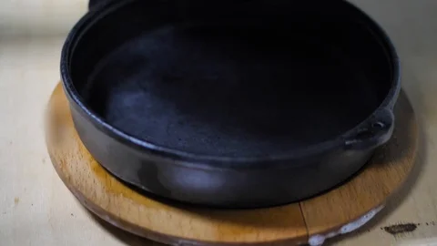 Close-up. chef puts the finished hot dish on a cast-iron pan. fried vegetables Stock Footage 126771337