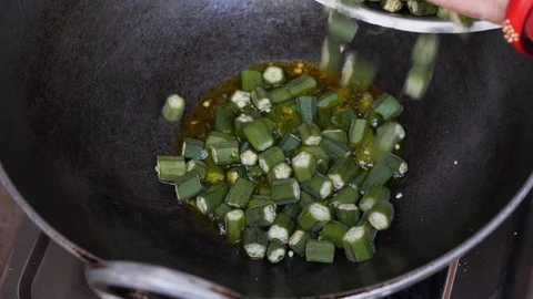 Close up of chef putting chopped vegetables into wok pan, Varanasi, India Stock Footage 145052954