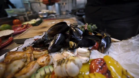 Close up chef putting fresh red pepper in a seafood and grilled vegetables dish 스톡 동영상 105272089