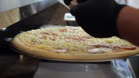 Close-up of a chef putting sausage on a pizza before baking in the kitchen. Stock Footage 341867971