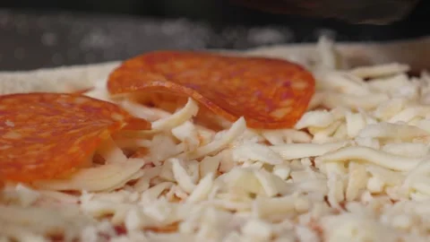 Close-up of the chef putting the sausage on the pizza dough. Pepperoni pizza. Stock Footage 345132138