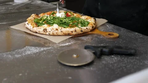 Close-up of a chef putting stracciatella cheese on a ready freshly baked pizza. Stock Footage 307389150