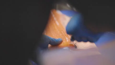 Close up of Chef removing bones from fish wearing gloves Stock Footage 151030023
