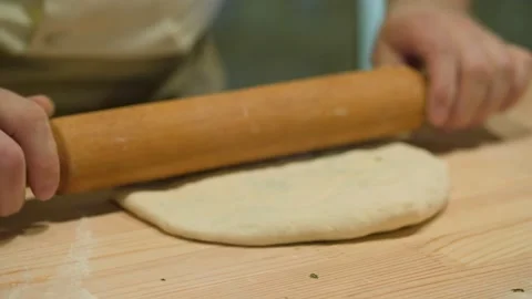 Close up of chef in the restaurants' open kitchen preparing dough for Stock Footage 139397424