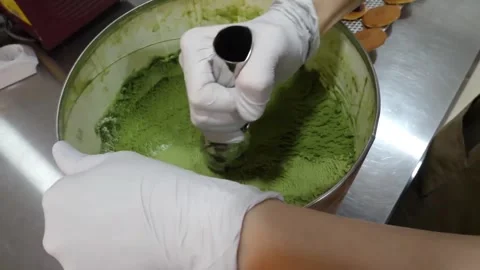 Close-up of Chef Scooping Green Matcha Ice Cream from Bowl Stock-Footage 345292489