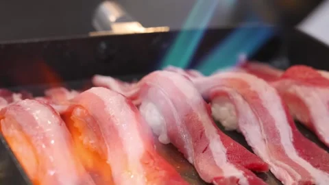 Close-up of Chef Searing Wagyu Beef Nigiri Sushi with a Blowtorch for Aburi Styl Stock Footage 333570056