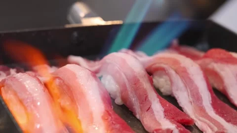 Close-up of Chef Searing Wagyu Beef Nigiri Sushi with a Blowtorch for Aburi Styl Stock Footage 333600543