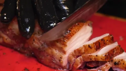 Close-up of Chef Slicing Juicy BBQ Roast Pork on Cutting Board Stock Footage 338212689