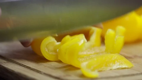 Close up of a chef slicing a red bell pepper on a wooden cutting board 動画素材 70759657