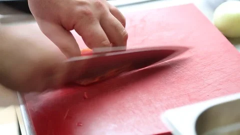 Close up of a chef slicing a red bell pepper on a  cutting board Stock Footage 83590314