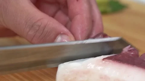Close-Up of Chef Slicing Red Radish for Decorative Garnish Stockbeeldmateriaal 333527036