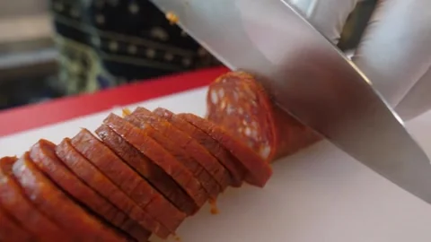 Close-up of Chef Slicing Spicy Pepperoni Salami for Authentic Italian Pizza Stock Footage 337676592