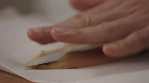 Close-Up of Chef Slicing Thin Fish Fillet on Parchment Paper Stock-Footage 321423639
