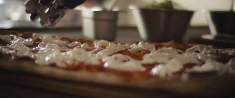 Close up of a chef spreading burrata cheese over a traditional al taglio pizz Stock Footage 146603853