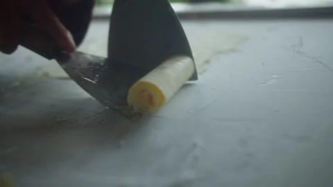 Close up of chef spreading mango ice cream on a frozen pan and carefully rolling Stock Footage 340083734