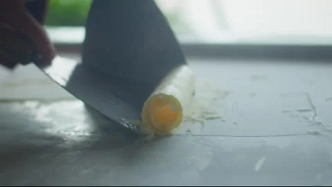 Close up of chef spreading mango ice cream on a frozen pan and carefully rolling Stock-Footage 340227906