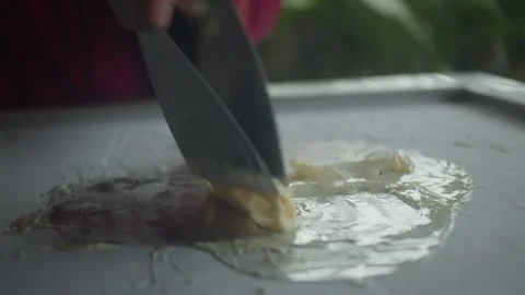 Close up of chef spreading mango ice cream on a frozen pan and carefully rolling 스톡 동영상 340774396