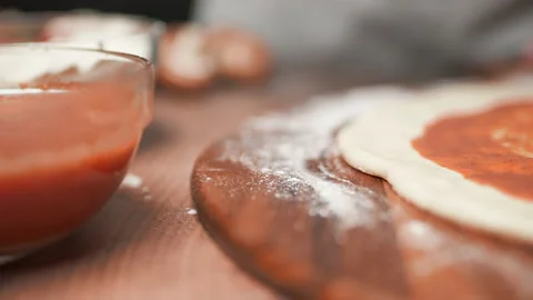 Close-up of chef spreading Tomato Sauce on pizza dough with a ladle in 4K. Stock Footage 137481908