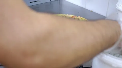 Close-up of a chef sprinkling pizza with fresh parsley in a restaurant kitchen. Stock Footage 319004983